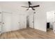 Bright bedroom features vinyl wood flooring, a ceiling fan, and closet storage at 13244 N 54Th Dr, Glendale, AZ 85304