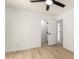 Clean bedroom with modern ceiling fan and wood-look flooring, connecting to the rest of the house at 13244 N 54Th Dr, Glendale, AZ 85304