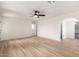 Spacious bedroom features a ceiling fan, wood-look flooring, and an archway into another room at 13244 N 54Th Dr, Glendale, AZ 85304