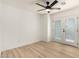 Bright bedroom featuring wood-look flooring, a ceiling fan, and access to a private balcony at 13244 N 54Th Dr, Glendale, AZ 85304