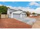 Beautifully landscaped home featuring a three-car garage, and modern exterior at 13244 N 54Th Dr, Glendale, AZ 85304