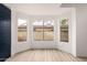 Bright and airy living room with bay windows, light wood floors, and stylish wallpaper accent wall at 13244 N 54Th Dr, Glendale, AZ 85304