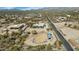 Expansive aerial view of property, showcasing horse pen, desert landscape, and neighborhood at 1345 E Gaffney Rd, New River, AZ 85087