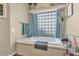 Bright bathroom featuring a large soaking tub and decorative glass block window at 1345 E Gaffney Rd, New River, AZ 85087