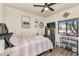 Bedroom featuring wood floors, ceiling fan, a window and stylish decor at 1345 E Gaffney Rd, New River, AZ 85087