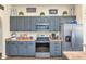 Well-lit kitchen with stainless steel appliances, plenty of counter space, and stylish grey cabinetry at 1345 E Gaffney Rd, New River, AZ 85087