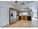 Bright kitchen with stainless steel refrigerator and black appliances, plus light wood cabinets at 13824 S 41St Way, Phoenix, AZ 85044