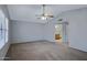 A large main bedroom with carpet flooring features a view into the en suite bathroom at 13824 S 41St Way, Phoenix, AZ 85044