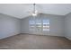 This spacious main bedroom has a ceiling fan and large windows at 13824 S 41St Way, Phoenix, AZ 85044