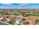 Aerial view of the home showcasing the tile roof, landscaping, and golf course and lake view at 13942 W Summerstar Dr, Sun City West, AZ 85375