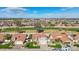 Aerial view of the home showcasing the tile roof, landscaping, and golf course view at 13942 W Summerstar Dr, Sun City West, AZ 85375