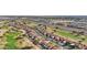 Aerial view of the neighborhood with lush green golf courses, nearby highways, and diverse shopping centers at 13942 W Summerstar Dr, Sun City West, AZ 85375