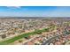 Expansive aerial view showcasing the community's golf course and red-tiled rooftops under a clear blue sky at 13942 W Summerstar Dr, Sun City West, AZ 85375