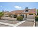 A single-Gathering home features a stucco exterior, red tile roof, desert landscaping, and a covered patio area at 13942 W Summerstar Dr, Sun City West, AZ 85375