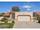 Attached two-car garage with a long driveway, desert landscaping, a well-maintained lawn, and a security screen door at 13942 W Summerstar Dr, Sun City West, AZ 85375