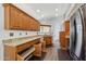 Spacious kitchen featuring natural wood cabinets, drawers with pull-outs, and granite countertops at 13942 W Summerstar Dr, Sun City West, AZ 85375