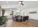 Bright living room featuring vaulted ceilings, wood-look tile floors, and comfortable leather seating arrangement at 13942 W Summerstar Dr, Sun City West, AZ 85375