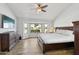 Well-lit main bedroom features a bay window with a view and hardwood flooring at 13942 W Summerstar Dr, Sun City West, AZ 85375