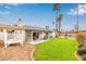 Expansive backyard oasis featuring a pool, patio, grassy area, palm trees, and plenty of sunshine at 14042 N 44Th St, Phoenix, AZ 85032