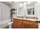 The bathroom features a wood vanity with dual sinks, a walk-in shower and is well-lit with natural lighting at 14042 N 44Th St, Phoenix, AZ 85032