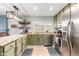 Well-lit kitchen with stainless steel appliances, tile floors, granite countertops, and olive colored cabinets at 14042 N 44Th St, Phoenix, AZ 85032