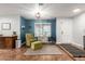 Comfortable living room with a chair, ottoman, and shelving next to a window with view of the front yard at 14042 N 44Th St, Phoenix, AZ 85032