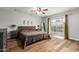 A primary bedroom with an oversized sliding glass door, wood floors, ceiling fan, and neutral colored walls at 14042 N 44Th St, Phoenix, AZ 85032