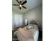 This bedroom features carpet, a ceiling fan, a mirror, and a bed with decorative pillows at 1511 E Lynx Way, Gilbert, AZ 85298