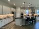 Modern kitchen with white cabinets, black countertops, stainless steel appliances, and pendant lighting at 1511 E Lynx Way, Gilbert, AZ 85298