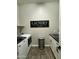 Well-organized laundry room featuring modern washer/dryer and stylish 'Laundry' wall decor at 1511 E Lynx Way, Gilbert, AZ 85298