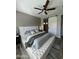 This main bedroom features a ceiling fan and a barn door leading to the attached bathroom at 1511 E Lynx Way, Gilbert, AZ 85298