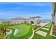 Backyard featuring a putting green, outdoor kitchen, pool, and travertine pavers at 1547 E Crescent Way, Gilbert, AZ 85298