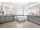 Bright bathroom featuring dual vanities, modern tub, and plantation shutters for privacy at 1547 E Crescent Way, Gilbert, AZ 85298