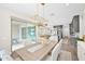 Bright dining area with modern lighting and sliding glass doors leading to the patio, seamlessly connecting to the kitchen at 1547 E Crescent Way, Gilbert, AZ 85298