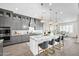 A modern kitchen with gray cabinets, granite countertops, stainless steel appliances, and elegant pendant lighting at 1547 E Crescent Way, Gilbert, AZ 85298