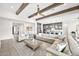 Spacious living room flowing into the kitchen, with comfortable seating, beamed ceilings, and a modern design at 1547 E Crescent Way, Gilbert, AZ 85298