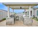 Covered outdoor kitchen equipped with a built-in grill, refrigerator, and ample counter space for al fresco dining at 1547 E Crescent Way, Gilbert, AZ 85298