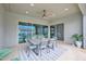 Outdoor dining area features a ceiling fan, an outdoor view of the beautiful pool and greenery at 1547 E Crescent Way, Gilbert, AZ 85298