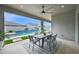 Outdoor living features dining area with an outdoor ceiling fan, a beautiful pool in the background at 1547 E Crescent Way, Gilbert, AZ 85298