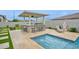 Outdoor poolside bar area with built in grill, stone facade, seating, and a shade structure at 1547 E Crescent Way, Gilbert, AZ 85298