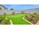 Backyard putting green with manicured landscaping and desert plants at 1547 E Crescent Way, Gilbert, AZ 85298