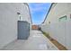 Long side yard with storage unit and gray stucco wall at 1547 E Crescent Way, Gilbert, AZ 85298