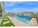 Relaxing pool area with refreshing water features, surrounded by a patio and a bar at 1547 E Crescent Way, Gilbert, AZ 85298