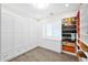 Organized walk-in closet with custom shelving, cabinets, and wood-style tile flooring at 1547 E Crescent Way, Gilbert, AZ 85298