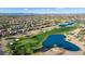 Beautiful aerial view of the neighborhood near a golf course, desert landscaping, and a lake at 16253 W Windcrest Dr, Surprise, AZ 85374