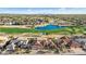 A picturesque aerial view of the home's location near a golf course, a lake, and desert landscaping at 16253 W Windcrest Dr, Surprise, AZ 85374