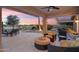 Covered patio offering seating, a grill, and a scenic view of the lake at 16253 W Windcrest Dr, Surprise, AZ 85374