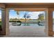 View of covered patio with a pool overlooking the golf course at 16253 W Windcrest Dr, Surprise, AZ 85374