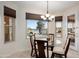 Charming dining area with views of the backyard and water at 16253 W Windcrest Dr, Surprise, AZ 85374