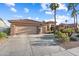 Charming single-story home with a well-manicured front yard, desert landscaping, and a two-car garage at 16253 W Windcrest Dr, Surprise, AZ 85374